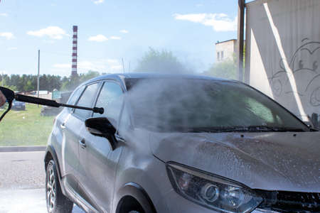 Grodno, Belarus - 01/06/2020: Washing a silver Renault Kaptur car on the first day of summer. The output from the isolation of coronavirusのeditorial素材
