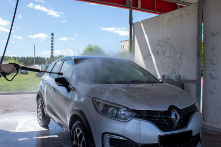 Grodno, Belarus - 01/06/2020: Washing a silver Renault Kaptur car on the first day of summer. The...