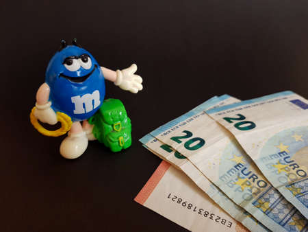 Grodno, Belarus-11.07.2020: m & m's Toy and Euro on black isolated background