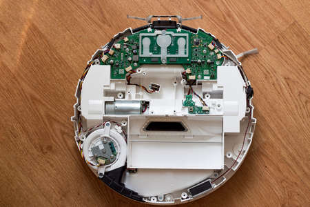 Repair of the robot vacuum cleaner. Disassembled robot vacuum cleaner close-up