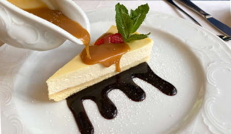 Cheesecake is a sweet dessert consisting of several layers. The main layer consists of a mixture of soft fresh cheese, eggs and sugar. The bottom layer consists of crushed cookiesの写真素材