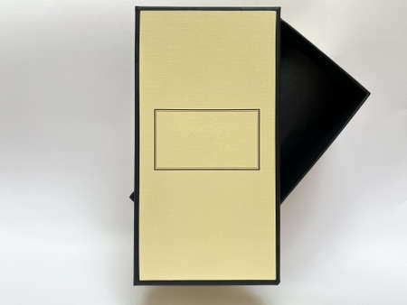 A bottle of perfume from a yellow box on a white isolated background