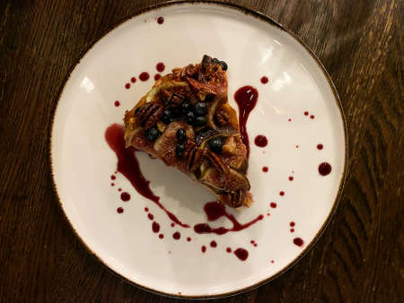 Apple charlotte sprinkled with walnuts, blueberries and figs on top