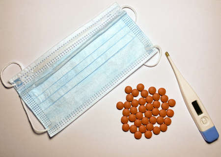 Ibuprofen, an electronic thermometer for measuring temperature and a face maskの写真素材