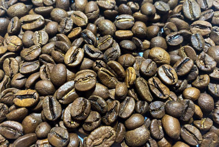 Background of Arabica coffee beans in close-up. Coffee bean texture