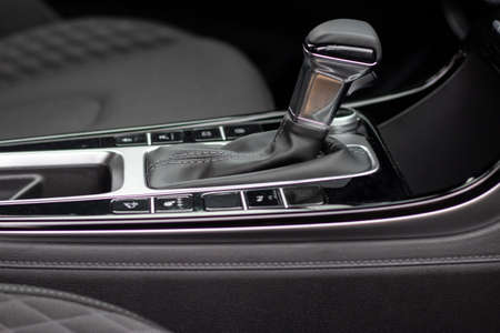 The interior of a new car. Automatic transmission in leather trim