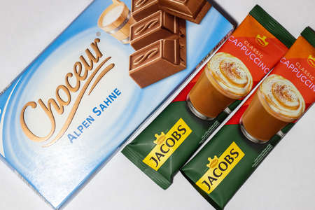 Grodno, Belarus - 12.15.2021: Milk chocolate Choceur Alpen Sahne and cappuccino coffee Jacobs Cappuccinoのeditorial素材