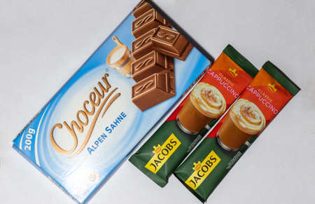 Grodno, Belarus - 12.15.2021: Milk chocolate Choceur Alpen Sahne and cappuccino coffee Jacobs Cappuccinoのeditorial素材
