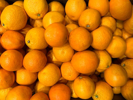 Background of sweet orange oranges or tangerines. Texture of oranges or tangerines. Oranges or...