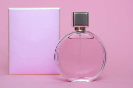 Perfume bottle from a pink box on an isolated background with mockup and copyspace