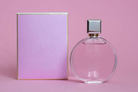 Perfume bottle from a pink box on an isolated background with mockup and copyspaceの写真素材