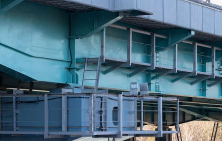 A road bridge over the river. Structures of the automobile bridge from below
