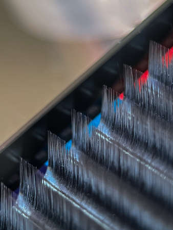 Classic eyelash extension. A palette of artificial eyelashes in close-up. Macrophotography of eyelashes for extensionの写真素材