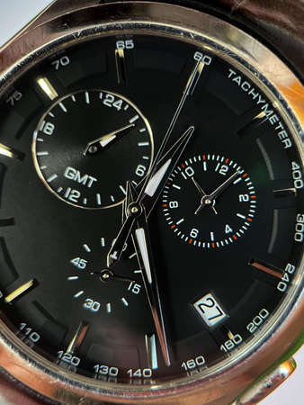 Luxury stainless steel watch with chronograph, black dial and metal bracelet close-up. Macrophotography of watch detailsの写真素材