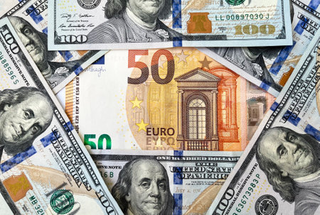 Background of one hundred dollar bills and fifty Euro bills close-up