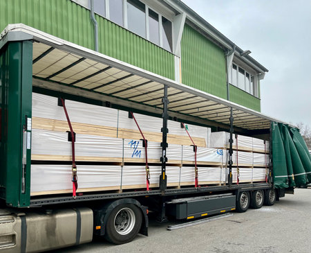 Transporting boards in a semi-trailer truck. Semi-trailer loaded with boards