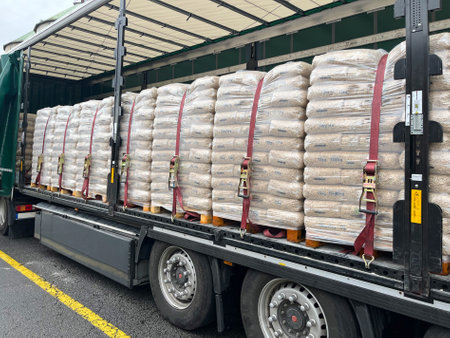 Packed wood pellets on pallets loaded into a semi-trailer for transportation