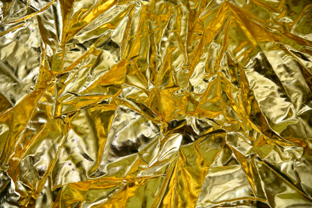 Golden creased steel metal reflector abstract background