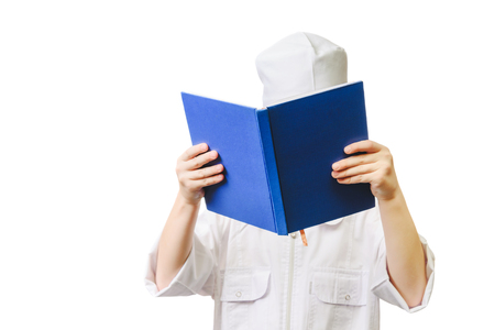 Young medical worker whith book close the face. Children doctor hold book.の写真素材