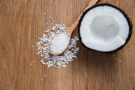 Coconut and old rustic spoon with flakesの写真素材