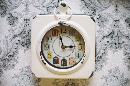 Old vintage clock on retro wall