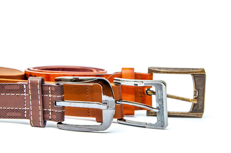 Accessories of men's wear leather belts on a white background. Men's leather belts on a white...