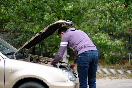 The man is repairing the car. Breakage of transport.