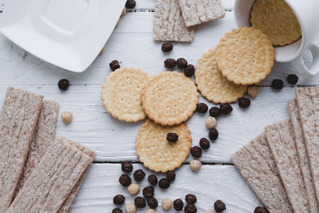 Flat lay dry snacks dietary breakfasts, dry biscuits and loaves on a wooden vintage table. Top view