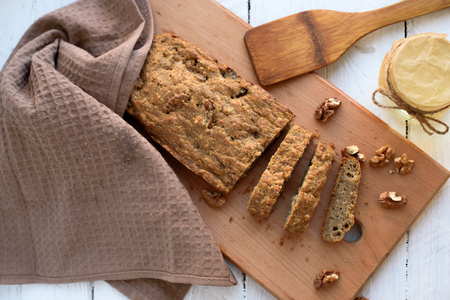 Homemade baking dietary bread with nuts, a flat lay, food photo in a rustic style.