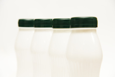 White plastic milk bottles on a white background