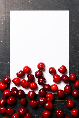 Fresh fruit cherry berry mock up over head view on black background, empty blank for recipe record kitchen notes.の写真素材