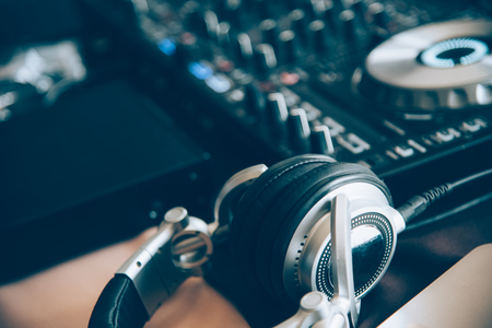 DJ equipment in the club, DJ headphones on the background of a mix control panelの写真素材