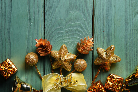 New Year's gifts, gold spangles, ornaments and baubles. Christmas background on wooden surface copy...