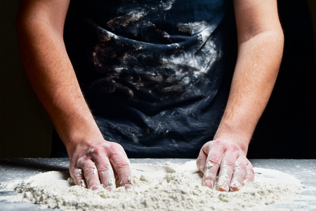 Cooking hands with flour in kitchen closeup