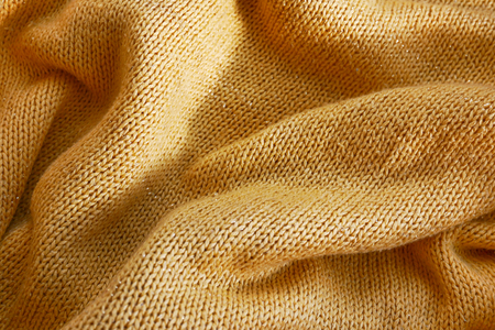 Fashion wavy of yellow color woolen fabric textile surface background.の写真素材