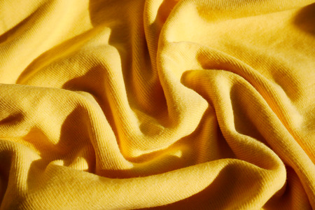 Yellow textile clothes wave background
