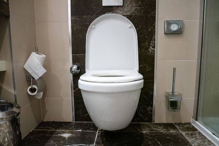 Room is a toilet with a white toilet. Toilet with marble floor.