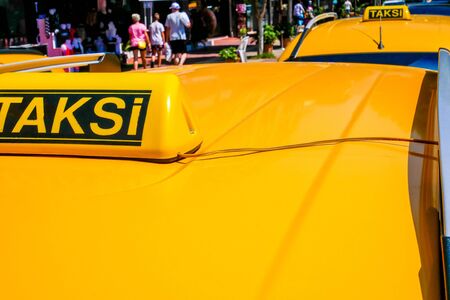 Taxi sign on yellow roof of the carの写真素材