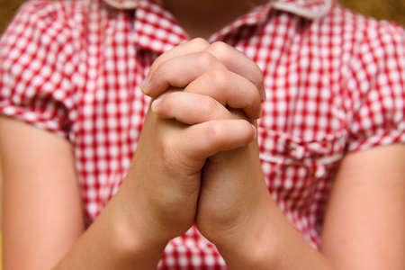 Hands of a praying child. Children's faith.の写真素材