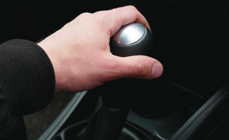Hand on the gearshift selector in the car, close-up. Right-hand drive cars.