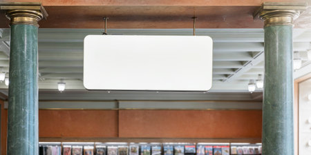 Suspended blank sign inside a vintage shop with classical columns and magazine racks in background....