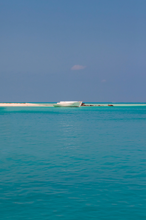 clear ocean water under blue sky whith boats and yachtの写真素材