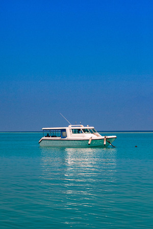 clear ocean water under blue sky whith boats and yachtの写真素材