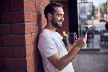 Man from behind  with phone in maskの写真素材