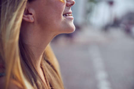 Cropped head pretty red-haired girl with long hair in empty city