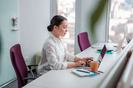 Asian woman working in IT officeの写真素材