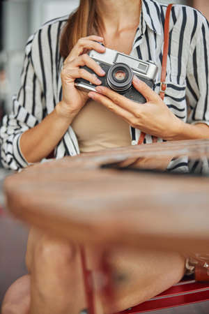Cropped up head of beautiful young woman photographer who is going to take pictures