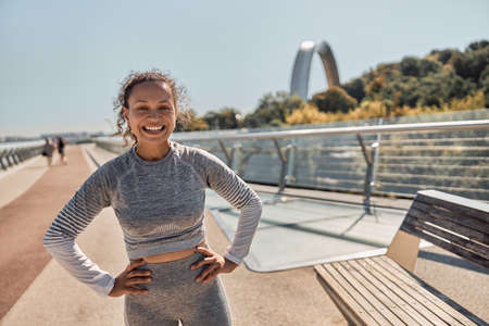 happy healthy and sporty woman is doing workout trainings in sunny day