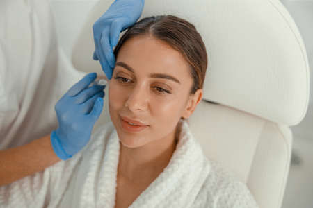 Beautiful healthy smiling caucasian woman is doing beauty procedures at spa and healthcare salon