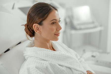 Beautiful healthy smiling caucasian woman is doing beauty procedures at spa and healthcare salonの写真素材